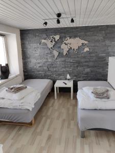 a room with two beds and a brick wall at 210 m2 hus med plads til 8 gæster in Nordborg
