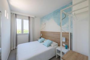 A bed or beds in a room at Venti di Laguna