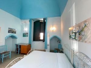a bedroom with a white bed and a table at GALLIPOLI DUESTANZE in Gallipoli +14 photos