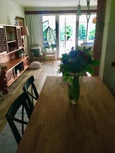 a vase of flowers sitting on a wooden table at Domeček u Marcelky in Ruprechtice