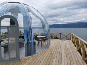 a glass dome on the deck of a house at Botnen Camping in Botnen