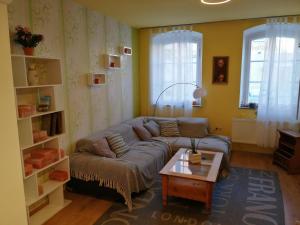 a living room with a couch and a coffee table at Ferienhaus Heideck in Heideck