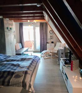 a bedroom with a bed and a living room at MeerMomente in Dorum Neufeld