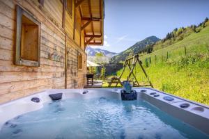 a jacuzzi tub with a view of a mountain at Chalet Levant Blanc - OVO Network in Seytroux