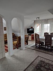 a living room with a table and a bedroom at Casa Irilen in Mănăstirea Humorului