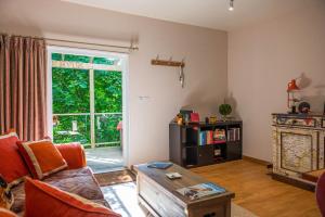 a living room with a couch and a table at THE HYDE- secret hide away, near the beach. in Truro