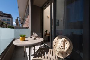 a small table and chairs on the balcony of a building at Dimitra Central Apts in Chania