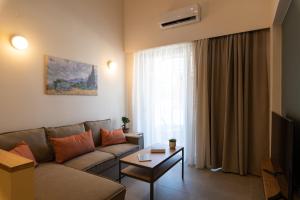 a living room with a couch and a table at Dimitra Central Apts in Chania Town
