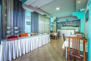 a dining room with a table and a bar at Villa Swiss in Ohrid
