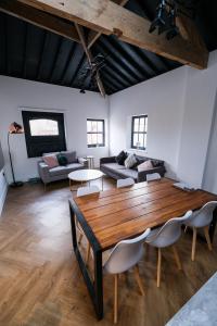 a living room with a wooden table and a couch at The Eden Warehouse - Green Apartment, sleeps 5 in Southport