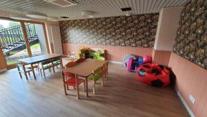 a room with a table and chairs and a soccer ball at Old Town Nadmotławie - Sauna & Gym I 10min deptak in Gdańsk