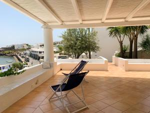a chair sitting on the balcony of a house at Nonna Pasqualina in Panarea