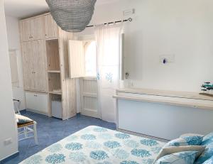 a bedroom with a bed and a room with a window at Nonna Pasqualina in Panarea