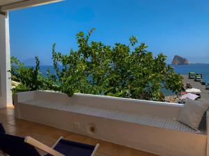 a room with a large window with a view of the ocean at Nonna Pasqualina in Panarea +10 photos