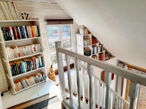 a staircase with book shelves filled with books at Charmante maisonnette en duplex au pied du Château in Nogent-le-Rotrou