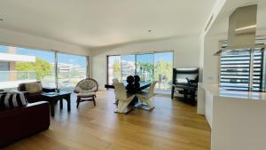 a living room with a couch and chairs and a tv at Prime by Check-in Portugal in Albufeira