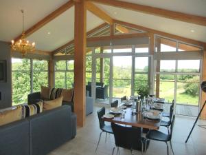 a dining room with a table and a couch at Apple Tree Lodges in Colchester