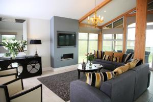 a living room with a couch and a fireplace at Apple Tree Lodges in Colchester