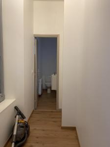a hallway with a room with a toilet and a vacuum at Villa des Thermes - T3 in Royat