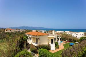 a house with a view of the ocean at Villa Aggeliki by Villa Plus in Pírgos Psilonérou
