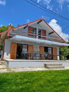 a house with chairs and a table in front of it at Mrežnica - Zelena oaza I in Generalski Stol