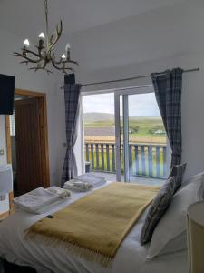 a bedroom with a bed and a large window at AURORA rural RETREATs in Glendale