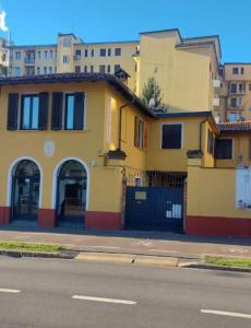 una casa gialla sul lato di una strada di Corte Della Varesina a Milano