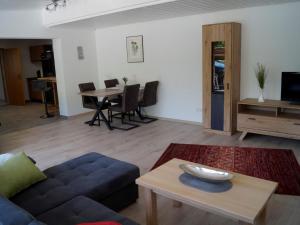 a living room with a couch and a table at Ferienwohnung Hegauliebe in Tengen