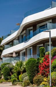 an office building with plants in front of it at Apartamentos Marivent by Brava Hoteles in Platja  d'Aro