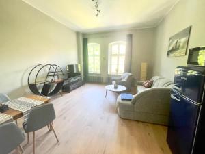 ein Wohnzimmer mit einem Sofa und einem Kühlschrank in der Unterkunft Leichtmatrose - Sternschanze in Stralsund