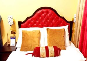 a bed with a red headboard and a red pillow at Trees Residences by Cail in Manila