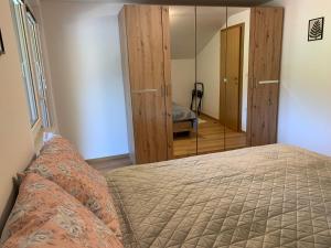a bedroom with a bed and a mirror at Apartmaji Prʼ nas in Laško
