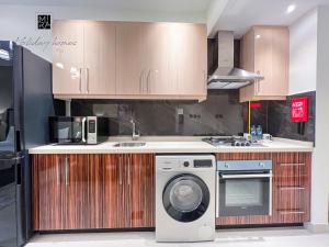 een keuken met een wasmachine en een wastafel bij Mira Holiday Homes - Newly furnished studio in Downtown in Dubai