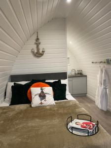 a bedroom with a large bed in a attic at Paddock Pod - Sleeps 4 & Roofed Over Private Hot Tub in Burnfoot