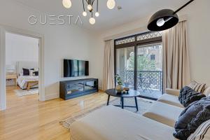 a living room with a couch and a tv at Yansoon by Emaar, Downtown Dubai in Dubai