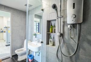 y baño con ducha, aseo y lavamanos. en Lavender Homes @ Jesselton Quay Kota Kinabalu en Kota Kinabalu