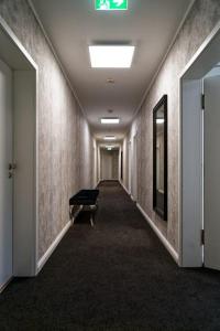 a hallway with a bench in the middle of a room at Hotel Dea in Soltau