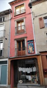 a building with clothes hanging in a window at File dans ta chambre ! in Le Monastier sur Gazeille