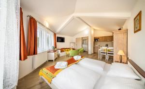 a bedroom with a bed and a living room at Villa Gardena in Český Krumlov