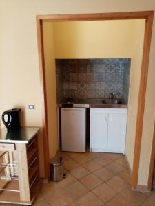 a kitchen with white cabinets and a sink at La Villa Rosace in Cerbère