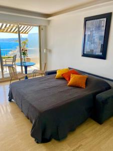 a bedroom with a large bed with a view of the ocean at Balcon du Mont Boron in Nice