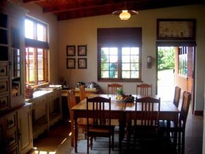 een keuken met een tafel en stoelen in een kamer bij Cedarwood Guest House in Howick