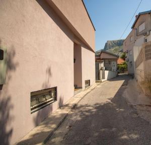 a building with an air conditioner on the side of a street at Sweet home in Mostar