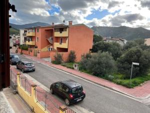a street with cars parked on the side of a road at Villa Magnolia in Muravera