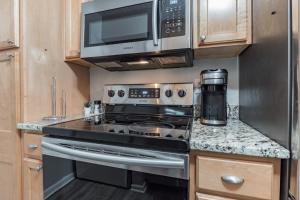 a kitchen with a stove and a microwave at Modern Cozy Townhome in Charlotte