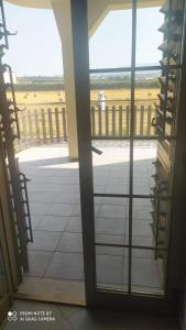 an open door to a balcony with a view of a field at La Fattoria B&B in San Marco Argentano