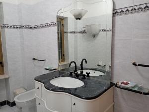 a bathroom with a sink and a toilet at La Fattoria B&B in San Marco Argentano