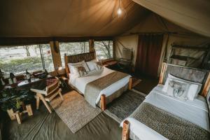 a bedroom with two beds in a tent at Mara Olapa Camp in Masai Mara +74 photos