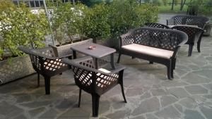 a group of chairs and tables on a patio at Hotel San Vitale in Medicina