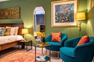um quarto com duas cadeiras azuis e uma cama em The Boutique York Garden Studio em York